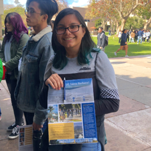 Student holding UC Santa Barbara brochure at UCSB